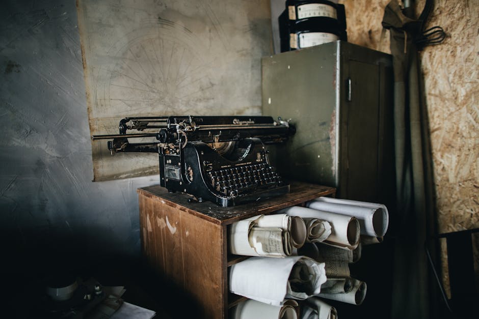 A classic typewriter atop a cabinet filled with rolled blueprints, creating a vintage office ambiance.