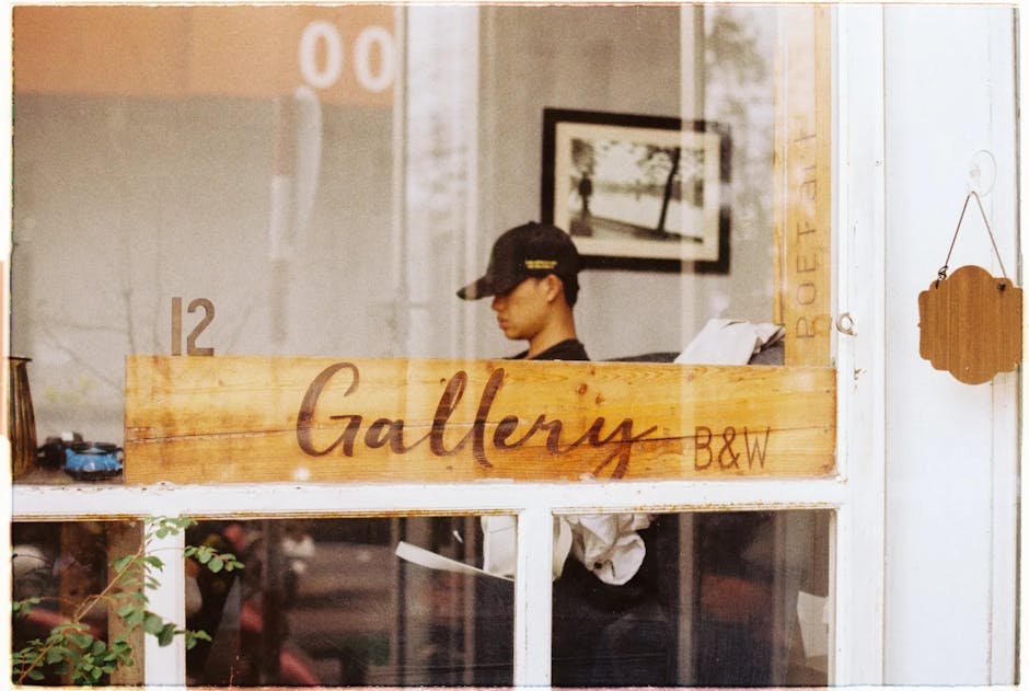 A man relaxing by a window in a Vietnamese art gallery.